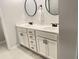 Modern bathroom features a double sink vanity with sleek black fixtures and stylish round mirrors at 251 Turner Ln, Woodstock, GA 30188