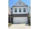 Charming two-story home with white siding, stone accents, and a spacious two-car garage, creating a welcoming facade at 251 Turner Ln, Woodstock, GA 30188