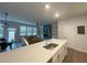 Modern kitchen open to living area, featuring a large island with a sink, stainless steel appliances, and ample counter space at 251 Turner Ln, Woodstock, GA 30188