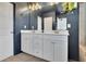 Stylish bathroom with a double sink vanity, and a large mirror at 5985 Hidden Ridge Ct, Cumming, GA 30028