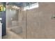 Modern tiled bathroom featuring a large shower with a glass door and built-in bench at 5985 Hidden Ridge Ct, Cumming, GA 30028