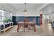 Charming dining room featuring modern wainscoting, wood floors, and a stylish light fixture at 5985 Hidden Ridge Ct, Cumming, GA 30028