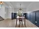 Well-lit dining room with elegant wainscoting and stylish chandelier at 5985 Hidden Ridge Ct, Cumming, GA 30028