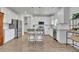 Modern kitchen with white cabinets, stainless steel appliances and a center island with barstool seating at 5985 Hidden Ridge Ct, Cumming, GA 30028
