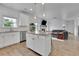 Open-concept kitchen with an island and view to the living room at 5985 Hidden Ridge Ct, Cumming, GA 30028