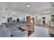 Open-concept living space flows to the modern kitchen with breakfast bar and stainless steel appliances at 5985 Hidden Ridge Ct, Cumming, GA 30028