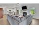 Spacious living room with a cozy fireplace and a view of the modern kitchen at 5985 Hidden Ridge Ct, Cumming, GA 30028