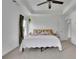 Bright primary bedroom with tray ceilings and a ceiling fan at 5985 Hidden Ridge Ct, Cumming, GA 30028