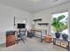 Bright home office space with a modern desk, chair, shelves, and a large window at 5985 Hidden Ridge Ct, Cumming, GA 30028