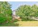 A lovely backyard featuring a deck and mature trees offering shade and privacy, with the house's rear entrance visible at 3311 Basking Shade Ln, Decatur, GA 30034