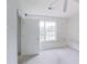 Bedroom with neutral walls, natural light from the window, and an open door at 3311 Basking Shade Ln, Decatur, GA 30034