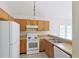 Kitchen featuring oak cabinets, white appliances and a stainless sink with tiled flooring at 3311 Basking Shade Ln, Decatur, GA 30034