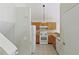 Kitchen with white appliances, light wood cabinets, and tiled floors, next to a flight of stairs at 3311 Basking Shade Ln, Decatur, GA 30034