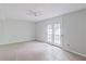 Living room with tiled floors, a ceiling fan, and a glass patio door leading to the yard at 3311 Basking Shade Ln, Decatur, GA 30034