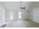 Living room with neutral carpet, ceiling fan, white trim, and natural light from two windows at 3311 Basking Shade Ln, Decatur, GA 30034