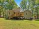 Expansive backyard with a deck, surrounded by mature trees and greenery, perfect for outdoor enjoyment at 4315 Hickory Point Dr, Canton, GA 30115