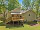 Backyard view featuring a spacious deck with awning, green lawn, and mature trees offering shade at 4315 Hickory Point Dr, Canton, GA 30115
