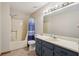 Bathroom with a blue vanity, modern fixtures, and combined tub and shower at 4315 Hickory Point Dr, Canton, GA 30115