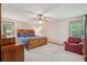 Bright bedroom with a large wooden bed, red chair, and plenty of natural light at 4315 Hickory Point Dr, Canton, GA 30115