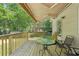 Inviting deck space with seating, table, and a retractable awning, perfect for enjoying the peaceful backyard at 4315 Hickory Point Dr, Canton, GA 30115