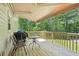 Outdoor deck with an awning, furniture, and views of the surrounding lush greenery for relaxing outdoors at 4315 Hickory Point Dr, Canton, GA 30115