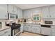 Bright kitchen with stainless steel appliances, neutral cabinetry, and a window view at 4315 Hickory Point Dr, Canton, GA 30115