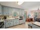 Kitchen view featuring stainless steel appliances and neutral cabinetry, connected to a dining area at 4315 Hickory Point Dr, Canton, GA 30115