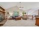 Open living room features a stone fireplace, neutral carpet, and easy access to the stairs at 4315 Hickory Point Dr, Canton, GA 30115