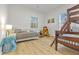 Bright bedroom featuring a twin bed, bunk beds, and a teddy bear next to the window at 1463 Metropolitan Sw Pkwy, Atlanta, GA 30310