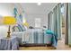 Charming bedroom with a striped comforter, beachy accents, and large sliding glass doors at 1463 Metropolitan Sw Pkwy, Atlanta, GA 30310