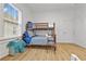 Cozy bedroom featuring a bunk bed, wood laminate floors, and natural light from the window at 1463 Metropolitan Sw Pkwy, Atlanta, GA 30310