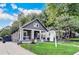 Charming home with a landscaped front yard, featuring a covered porch with elegant columns and ample parking at 1463 Metropolitan Sw Pkwy, Atlanta, GA 30310