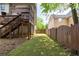 A narrow strip of backyard with a wood fence adjoins the raised deck and home at 2975 Oak Hampton Way, Duluth, GA 30096
