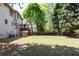 Spacious backyard with a wooden fence, deck, and play set for Gathering fun at 2975 Oak Hampton Way, Duluth, GA 30096