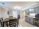 Finished basement featuring a dining table next to a kitchenette with gray cabinets and a mini-refrigerator at 2975 Oak Hampton Way, Duluth, GA 30096