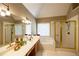 Bathroom with double vanity, large mirror, separate shower, jacuzzi tub, and natural light at 2975 Oak Hampton Way, Duluth, GA 30096