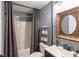 Bathroom with shower and tub, vanity, decorative mirror, toilet, and gray walls at 2975 Oak Hampton Way, Duluth, GA 30096