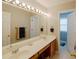 Bathroom featuring double sinks with a large mirror and stylish lighting at 2975 Oak Hampton Way, Duluth, GA 30096