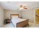 Cozy bedroom with neutral colors, a ceiling fan, and two side tables with reading lamps on either side at 2975 Oak Hampton Way, Duluth, GA 30096