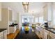 Open kitchen with a black granite island that connects to a breakfast nook and desk area at 2975 Oak Hampton Way, Duluth, GA 30096