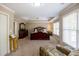 Spacious main bedroom showcasing trey ceiling, windows, carpet, and a sitting area at 2975 Oak Hampton Way, Duluth, GA 30096