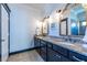Bathroom with double sinks, granite countertops, and updated faucets and fixtures at 1014 Braeburn Ln, Decatur, GA 30030