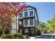 Modern three-story townhome with white siding, black trim, and a well-maintained landscape at 1014 Braeburn Ln, Decatur, GA 30030