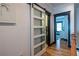 Hallway with sliding barn door, wood floors, and bedroom at the end at 1014 Braeburn Ln, Decatur, GA 30030