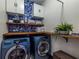 Modern laundry room with front-load washer and dryer, and storage cabinets at 1014 Braeburn Ln, Decatur, GA 30030