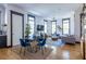 Living room with large windows, hardwood floors, comfortable furniture and a view into the modern eat-in kitchen at 1014 Braeburn Ln, Decatur, GA 30030