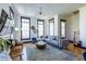 Bright and airy living room with large windows, hardwood floors, stylish decor, and a comfortable sectional sofa at 1014 Braeburn Ln, Decatur, GA 30030