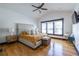 Main bedroom with wood floors, ceiling fan, black trim, and large bed at 1014 Braeburn Ln, Decatur, GA 30030