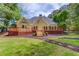 Charming backyard showcasing a spacious deck, meticulous lawn, and an inviting decorative mulch pathway at 12340 Preserve Ln, Alpharetta, GA 30005