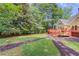 Expansive backyard with a large deck, meticulously maintained lawn and decorative mulch path at 12340 Preserve Ln, Alpharetta, GA 30005